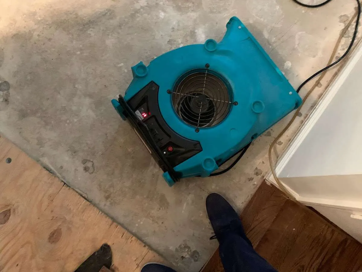 Air mover drying subfloor during Commercial Water Damage Restoration in Mahomet